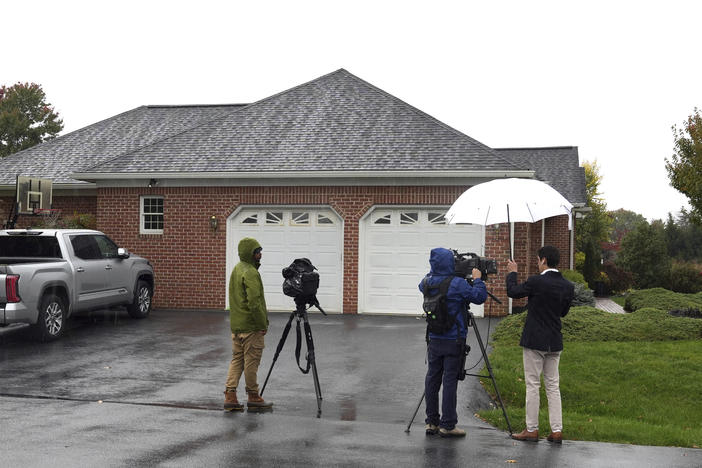 News crews film outside the home of Maryland Circuit Court Judge Andrew Wilkinson on Friday in Hagerstown, Md. Authorities say Wilkinson, who was shot to death in the driveway of his home, had presided over the divorce case of the man now identified as a suspect in the killing.