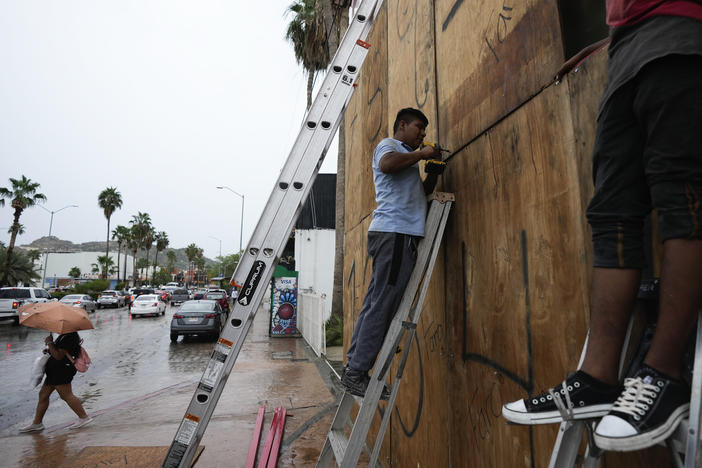 Employees cover the windows of a souvenirs store with wood in preparation for the arrival of Hurricane Norma, in Cabo San Lucas, Mexico, on Friday.