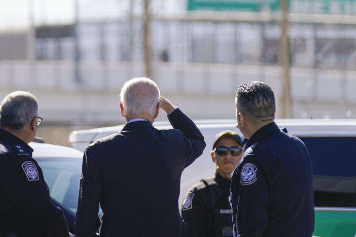 President Biden looks toward a large "Welcome to Mexico" sign that is hung over the Bridge of the Americas as he tours the port of entry in El Paso Texas on Jan. 8.