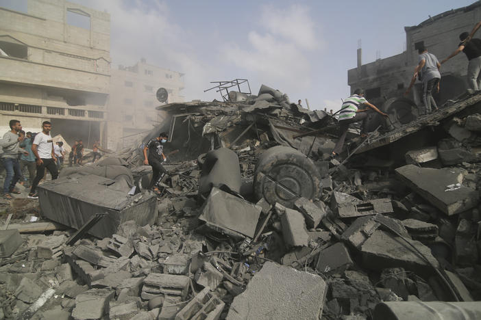 Palestinians look for survivors in buildings destroyed in the Israeli bombardment of the Gaza Strip in Rafah on Sunday.
