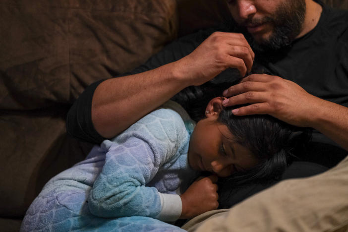 Jose Grajeda and daughter, Victoria. <strong>"</strong>If I wanted to go to sleep as a child, I would go cuddle with my mom and she would give me <em>piojito</em>," he says — Spanish for "little lice." The late Peruvian linguist Martha Hidlebrandt described <em>piojito</em> as "gently scratching the scalp of a child as if he were being relieved of the itching of imaginary lice" — hence the name.