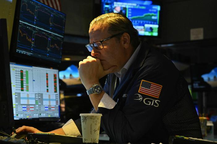 A trader works at the New York Stock Exchange on Oct. 11. Bond yields are surging, threatening to raise borrowing costs across the economy.