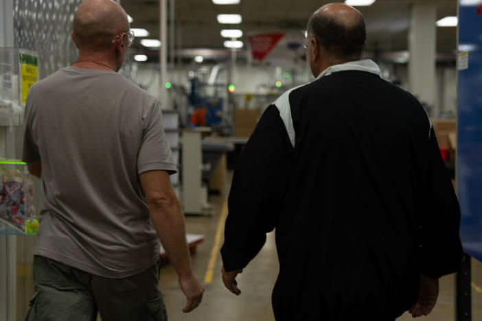 Roman (left) is a Ukrainian refugee who works at ComDel Innovation in Wahpeton, N.D. CEO Jim Albrecht (right) says the company has been working with a program called Uniting For Ukraine that provides a legal pathway for Ukrainians to come to the U.S. and work for up to two years.