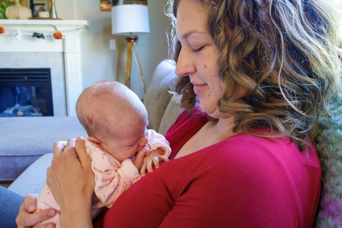 Emily Bendt cradles her two-week-old infant, Willow, at her home near Portland, OR in early October 2023. Bendt, a pediatric nurse, closely followed the recent approval of the RSV monoclonal antibody Nirsevimab but has been unable to find it for her daughter.