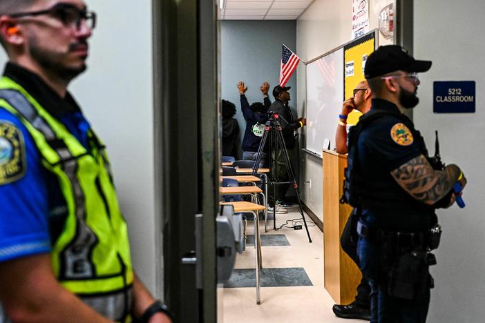 Miami fire and rescue and police officers perform a rescue operation during an active shooter drill at Miami Senior High School in Miami, Fla.