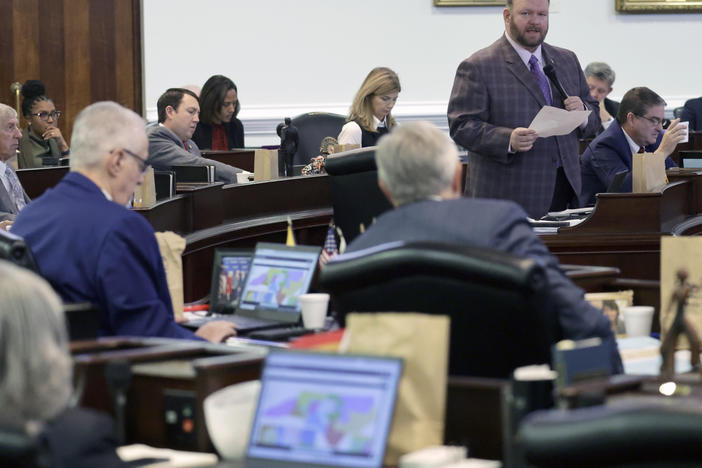 While other senators look at the map on their computers, Republican Sen. Ralph Hise, top right, one of the sponsors of a congressional redistricting bill, speaks as the North Carolina Senate debates the bill Tuesday in Raleigh, N.C.