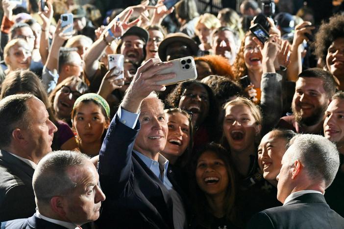 President Biden takes a selfie with supporters during a rally in New York ahead of the 2022 midterm elections.