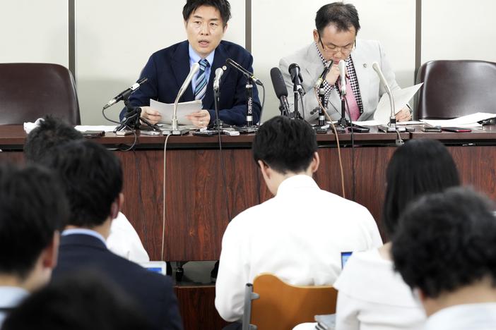 The unnamed plaintiff's lawyers, Kazuyuki Minami, left, and Masafumi Yoshida, right, speak to media after the ruling of the Supreme Court on Wednesday in Tokyo.