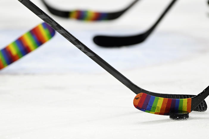 The NHL embraced Pride Tape soon after it was created, then it banned it — and now it is welcoming the colorful tape once again. Here, players warm up before a Pride Night game in 2022.