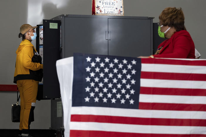 A voter marks her ballot during early voting, on Oct. 17, 2022, in Atlanta.