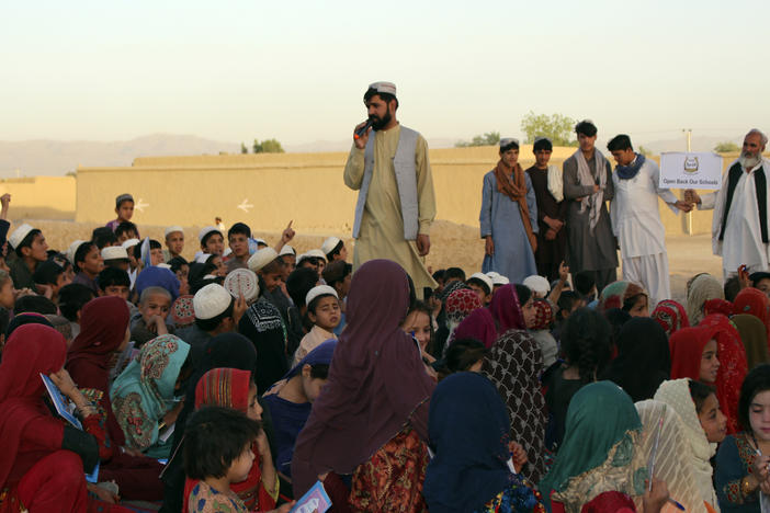 Matiullah Wesa, a girls' education advocate, reads to students in Spin Boldak district in Kandahar province of Afghanistan on May 21, 2022. The Taliban have freed the Afghan activist who campaigned for the education of girls, a local nonprofit organization said Thursday. Wesa was arrested seven months ago and spent 215 days in prison, according to the group, Pen Path.