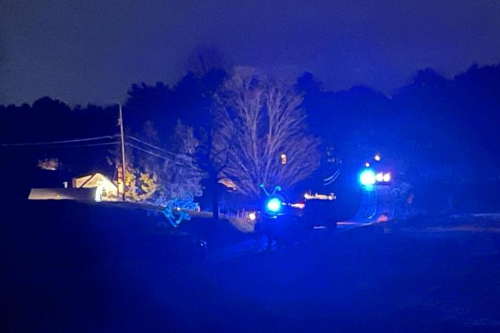 Law enforcement officials surround a house on Meadow Road in Bowdoin, Maine.