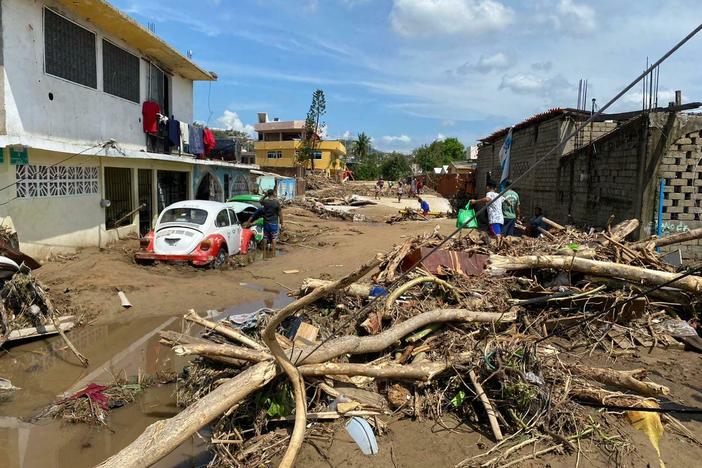 A river carried mud and downed trees in the Zapata neighborhood on the outskirts of the city of Acapulco, Mexico, after Hurricane Otis swept through the area.