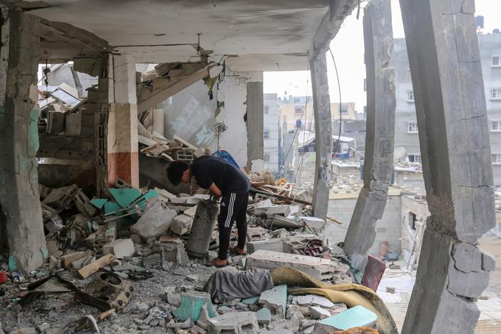 People search through buildings that were destroyed during Israeli air raids in the southern Gaza Strip on Saturday in Khan Yunis, Gaza.