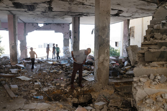 People walk through the ruins of Al-Ansar Mosque in Jenin refugee camp in the northern occupied West Bank that was hit last week by an Israeli airstrike.