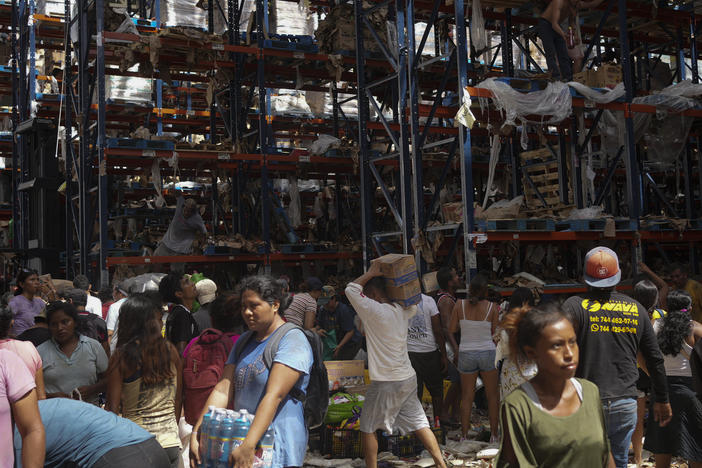 People take items from stores in the aftermath of Hurricane Otis in Acapulco, Mexico, Saturday, Oct. 28, 2023.