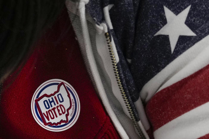 A poll worker has an "Ohio Voted" sticker on her shirt during early in-person voting at the Hamilton County Board of Elections in Cincinnati on Oct. 11. Ohio has a constitutional amendment before voters this year that would include reproductive health protections in the state's constitution, including abortion rights.