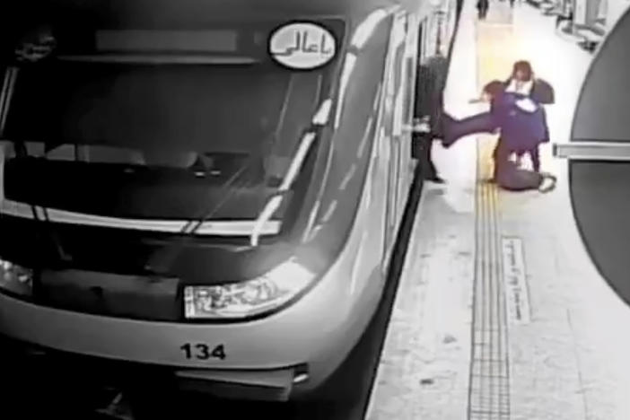 In this image from surveillance video aired by Iranian state television, women pull 16-year-old Armita Geravand from a train car on the Tehran Metro in Tehran, Iran, Sunday, Oct. 1, 2023.