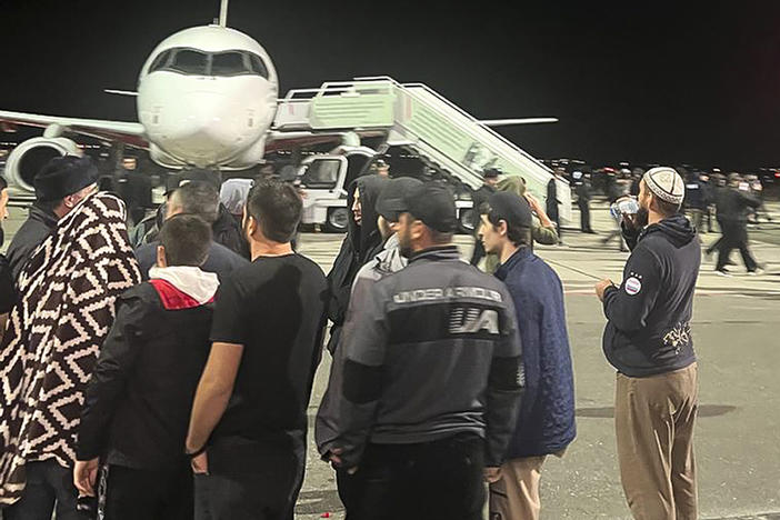 A crowd swarms the airfield of the airport in Makhachkala, capital of Dagestan in southern Russia, on Sunday night.