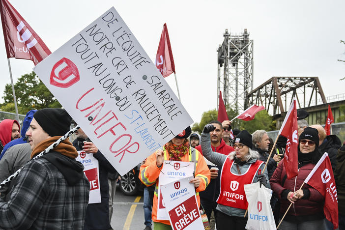 Striking St. Lawrence Seaway workers picket outside the St. Lambert Lock in St. Lambert, Quebec, Monday, Oct. 23, 2023.