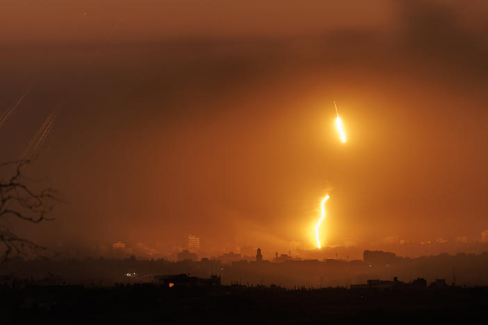 Rockets and "light bombs" are seen over the Gaza strip on Monday, Oct. 30, 2023, from Sderot, Israel. As Israel's response to Hamas's Oct. 7 attacks entered its fourth week, Israeli Prime Minister Benjamin Netanyahu said the war would be a long one and would amount to a "second war of independence."