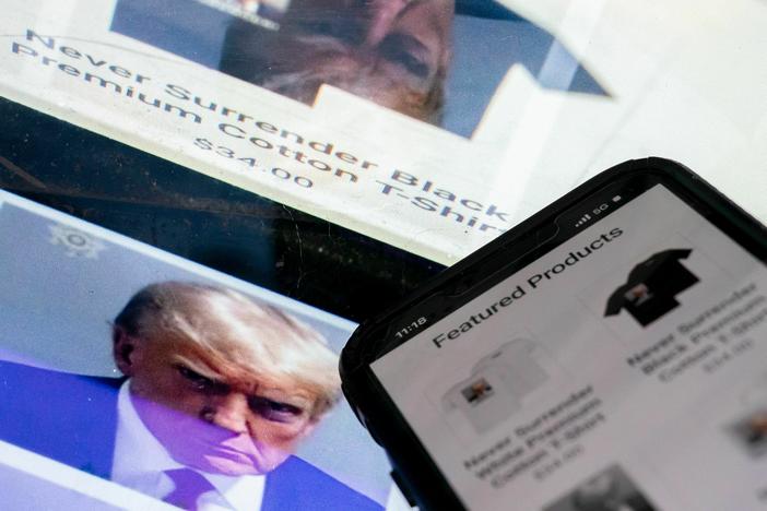 This photo illustration shows the mugshot of former President Donald Trump next to a website called Trump Save America JFC, a joint fundraising committee on behalf of Donald J. Trump for President 2024, which is selling merchandise bearing his mugshot.