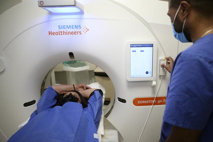 A patient gets a low-dose CT scan to screen for lung cancer. The American Cancer Society on Wednesday recommended expanding who should have this annual screening test.