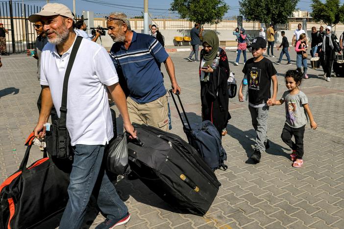 People enter the Rafah border crossing in the southern Gaza Strip before crossing into Egypt on Wednesday.