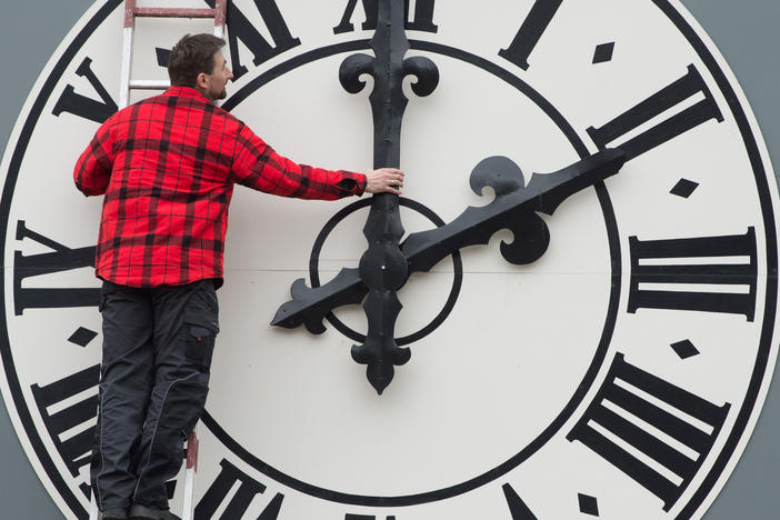 This picture taken in March 2018 shows a technician working on the clock of the Lukaskirche Church in Dresden, eastern Germany. This weekend, Americans will wind back this clocks as daylight saving time ends.
