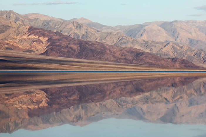 The sun rises beyond the sprawling temporary lake at Badwater Basin salt flats on October 23.