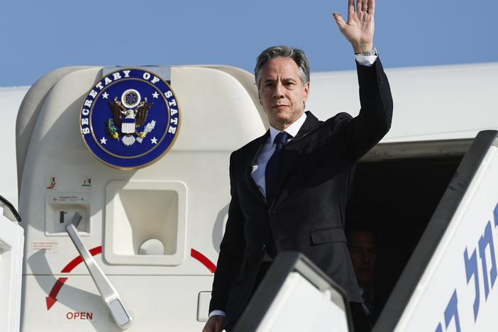 U.S. Secretary of State Antony Blinken waves as he disembarks from an aircraft on his arrival in Tel Aviv, Israel, on Friday.