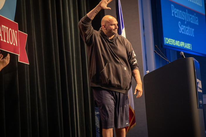 Pennsylvania Sen. John Fetterman walks onto stage in his trademark Carhart hoodie and basketball shorts Saturday night at Prairie Meadows Casino in Altoona, Iowa. Fetterman was the featured speaker at the Iowa Democratic Party's Liberty and Justice Celebration on Nov. 4.