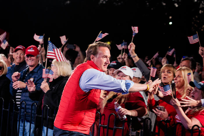 Gov. Glenn Youngkin shakes hands with supporters during a Secure Your Vote Rally on Oct. 23 in Glen Allen, Va.