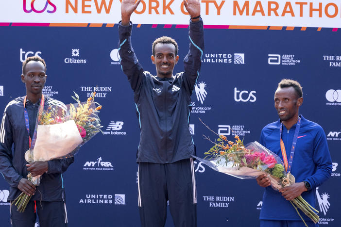 From left, second place finisher Albert Korir of Kenya, first place finisher Tamirat Tola, of Ethiopia, and third place finisher Shura Kitata, also from Ethiopia, pose after the men's division of the New York City Marathon on Sunday.