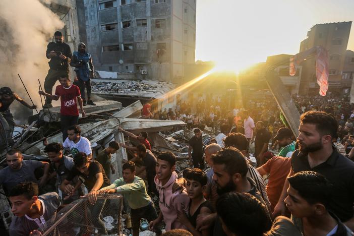People search through buildings that were destroyed during Israeli air raids in the southern Gaza Strip Saturday in Khan Yunis, Gaza.