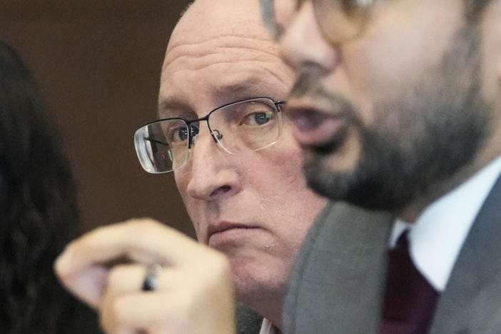 Robert E. Crimo Jr., left, listens Friday to his attorney George Gomez while he speaks to Judge George D. Strickland during an appearance at the Lake County Courthouse in Waukegan, Ill.