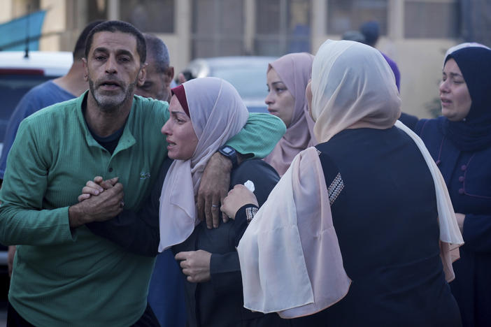 Palestinians mourn relatives killed in the Israeli bombardment of the Gaza Strip in front of the morgue in Deir al Balah on Monday.