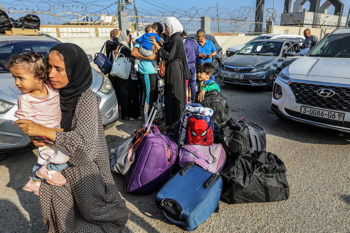 Palestinians with foreign passports at Rafah Border Gate wait to cross into Egypt, Nov. 1.