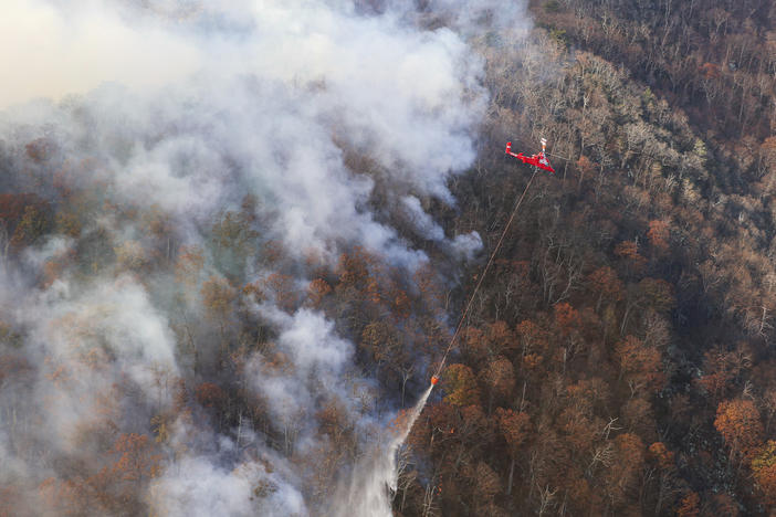 This photo provided by the Virginia Department of Forestry shows firefighters trying to stop the western spread of the Quaker Run Wildfire in Madison County, Va.