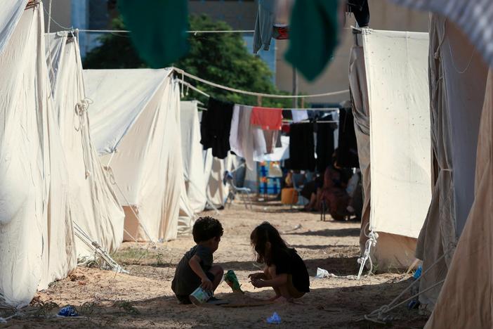 Children play among tents set up for Palestinians seeking refuge on the grounds of an UNRWA center in Khan Younis in the southern Gaza Strip on Oct. 19.