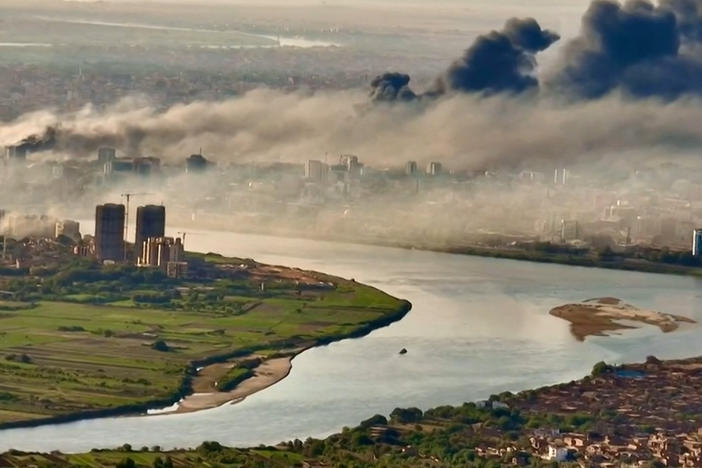 This video grab taken from AFPTV video footage on April 19, 2023, shows an aerial view of black smoke covering the sky above the capital Khartoum.