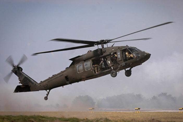Military personnel of the U.S. Army's 101st Airborne Division take off with a Black Hawk helicopter during a demonstration drill at Mihail Kogalniceanu Airbase near Constanta, Romania on July 30, 2022. A Black Hawk helicopter crashed over the weekend in the Mediterranean Sea.