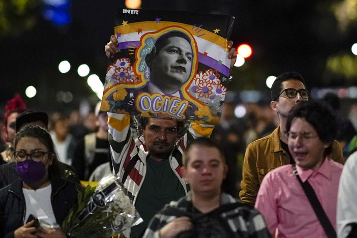 Demonstrators march with a picture of Aguascalientes state electoral court magistrate Jesus Ociel Baena in Mexico City, Monday, Nov. 13, 2023.