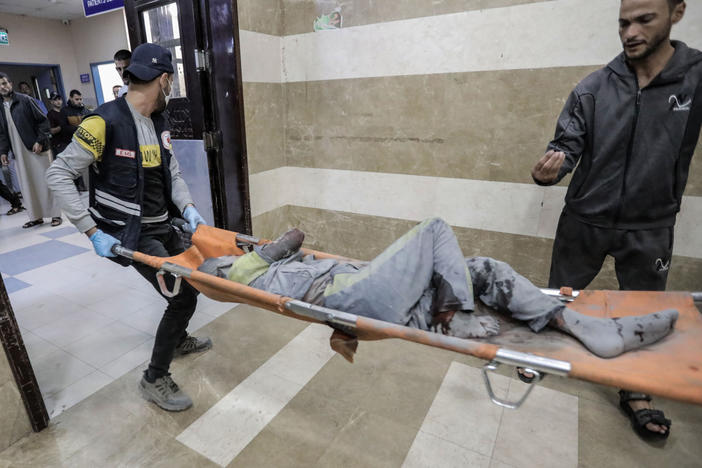 Palestinians injured in Israeli raids arrive at Nasser Medical Hospital on Tuesday in Khan Younis, Gaza.