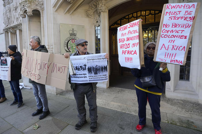 Protesters stand outside the Supreme Court in London on Wednesday.