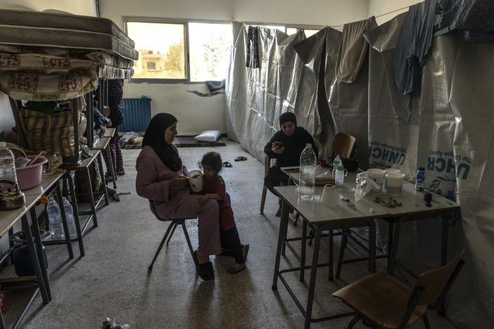 An internally displaced woman feeds her daughter at their room in a school reconverted as a temporary center for internally displaced people on Oct. 25, in Tyre, Lebanon. The International Organization for Migration reported 19,646 people had been displaced inside Lebanon since Oct. 8, the day after an assault on Israel by Hamas militants.