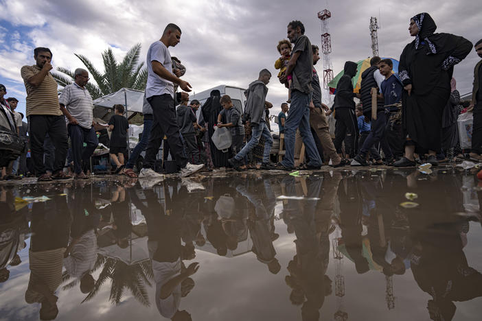Palestinians displaced by the Israeli bombardment of the Gaza Strip walk in a United Nations Development Programme-provided tent camp in Khan Younis,Nov.15, 2023.