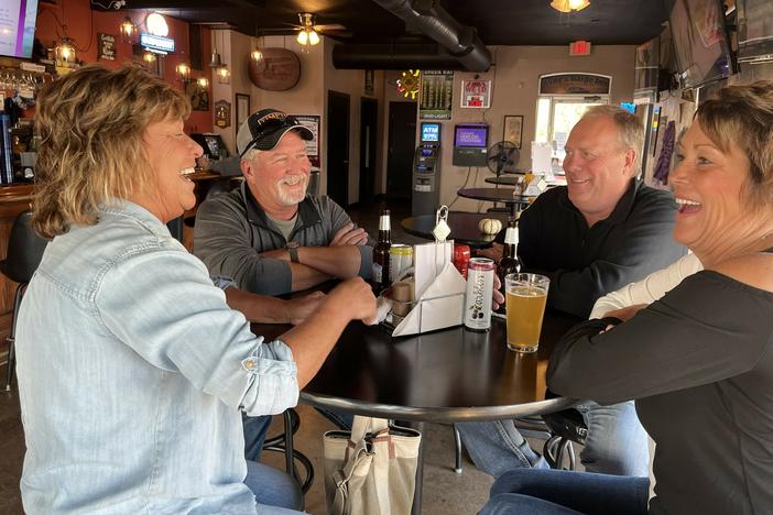 Darla Chaddock (left) and her husband, Rob Chaddock, share a drink with their friends Michelle and Kenny Stone (right) at Judy's Barge Inn in Buffalo, Iowa.
