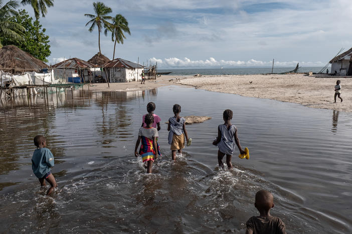 Children wade through floodwater on Nyangai Island, Sierra Leone. Most of the island has already been lost to the sea, and what remains is routinely flooded at high tide.