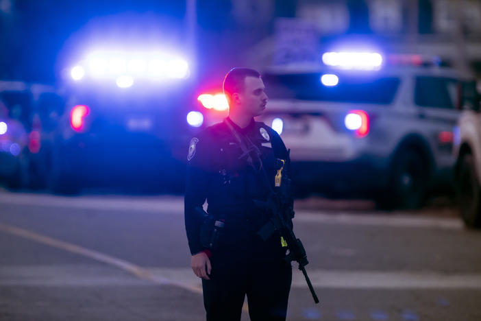 Police work outside the New Hampshire Hospital where officials said several people were shot on Friday.